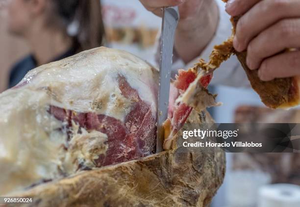 Portuguese Chef Vitor de Oliveira slices into a smoked ham at Porto-Norte stand as part of the presentation of the touristic "Rota do Presunto...