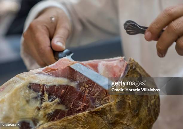 Portuguese Chef Vitor de Oliveira slices into a smoked ham at Porto-Norte stand as part of the presentation of the touristic "Rota do Presunto...