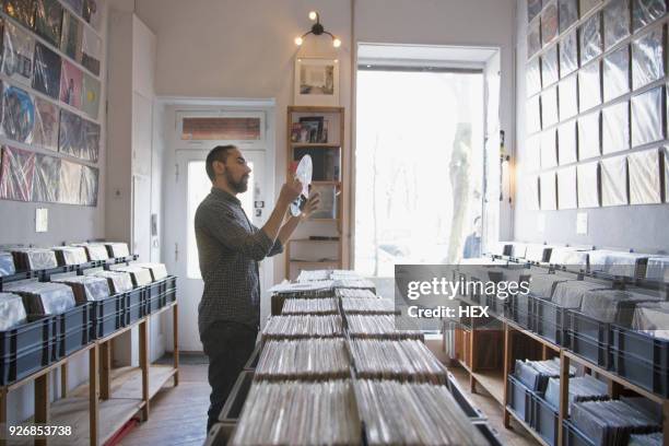 young man shopping for records - record store stock pictures, royalty-free photos & images