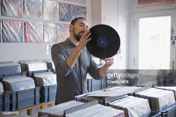 young man shopping for records - plattenladen stock-fotos und bilder