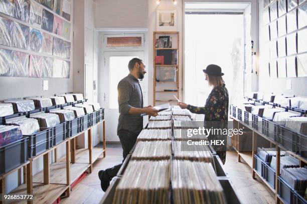 young couple shopping for records together - record shop stock pictures, royalty-free photos & images