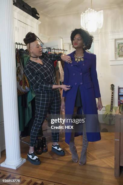 A young woman trying on a coat