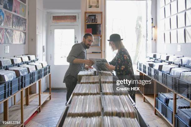 young couple shopping for records together - plattenladen stock-fotos und bilder