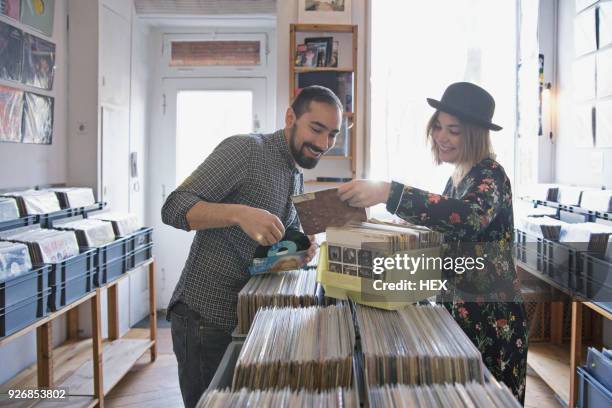 young couple shopping for records together - plattenladen stock-fotos und bilder