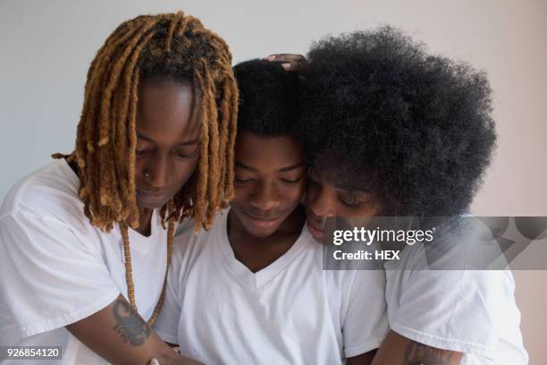 lesbian couple with their son - teen lesbians stock pictures, royalty-free photos & images