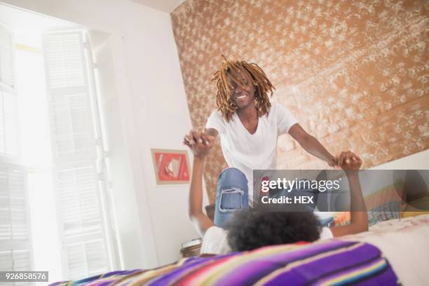 lesbian couple wrestling in their bedroom - female wrestling holds stock pictures, royalty-free photos & images