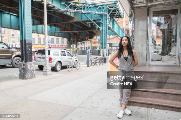young woman near a bridge in queens, new york - queensday stock-fotos und bilder