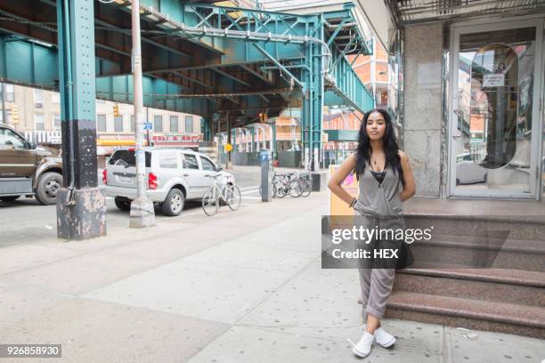 young woman near a bridge in queens, new york - queens new york city bildbanksfoton och bilder