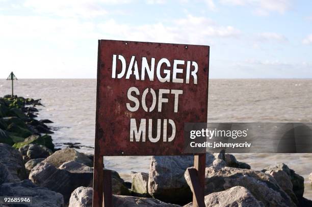 danger soft mud... - quicksand stock pictures, royalty-free photos & images