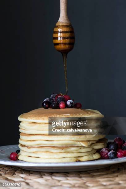 stack of pancakes with blueberries and honey - honey dipper stock pictures, royalty-free photos & images