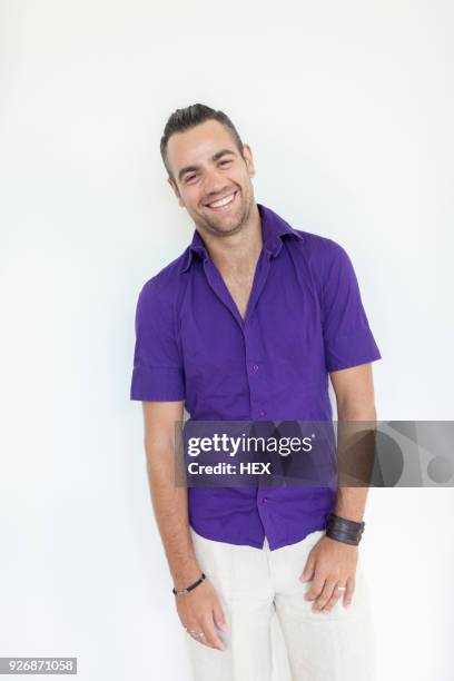 portrait of a young man in a purple shirt - purple shirt stock pictures, royalty-free photos & images
