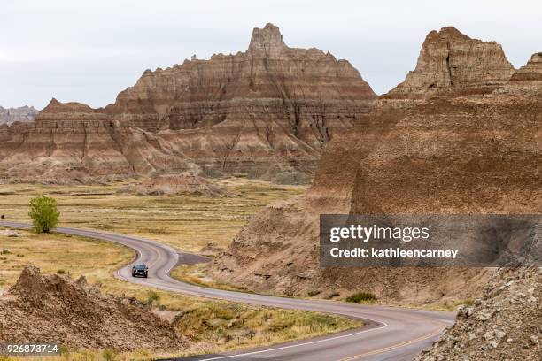 car driving along winding road, badlands national park, south dakota, america, usa - badlands national park stock pictures, royalty-free photos & images