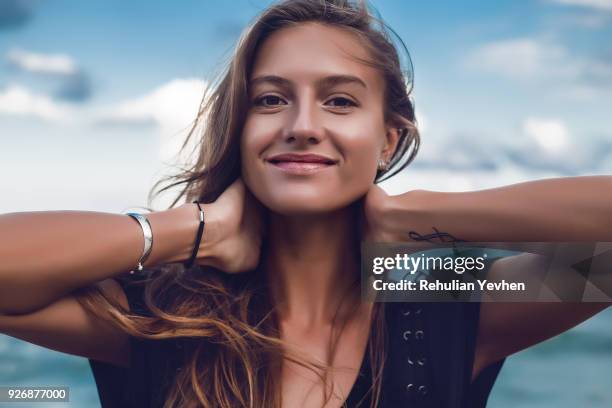 portrait of happy young woman on beach, head and shoulders, odessa, odessa oblast, ukraine - junge frau allein stock-fotos und bilder