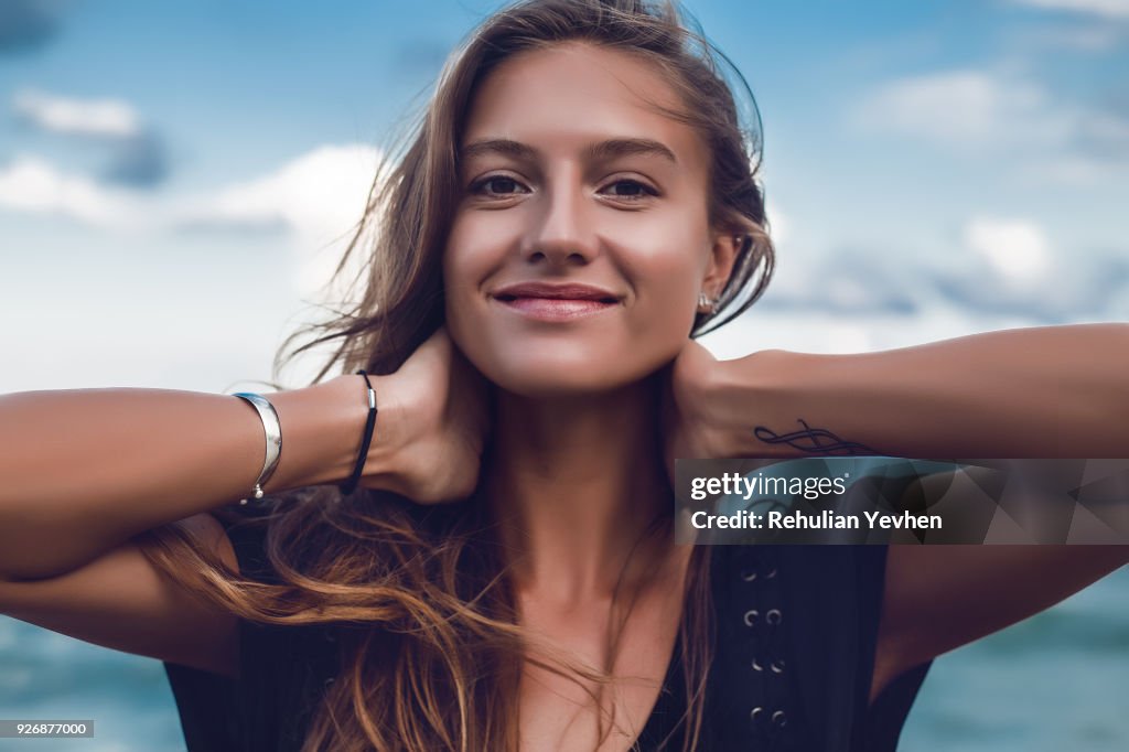 Portrait of happy young woman on beach, head and shoulders, Odessa, Odessa Oblast, Ukraine