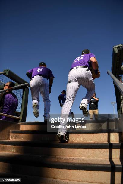 Colorado Rockies shortstop Daniel Castro and left fielder David Dahl head to the field for the game against the Milwaukee Brewers on March 3, 2018 at...