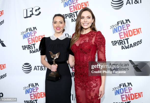 Actors Aubrey Plaza and Elizabeth Olsen pose with the Best First Feature award for 'Ingrid Goes West' in the press room during the 2018 Film...