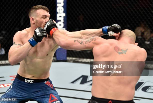 Jordan Johnson and Adam Milstead trade punches in their light heavyweight bout during the UFC 222 event inside T-Mobile Arena on March 3, 2018 in Las...