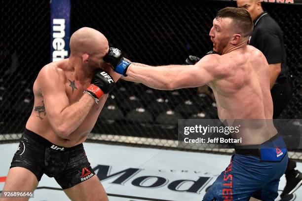 Adam Milstead punches Jordan Johnson in their light heavyweight bout during the UFC 222 event inside T-Mobile Arena on March 3, 2018 in Las Vegas,...