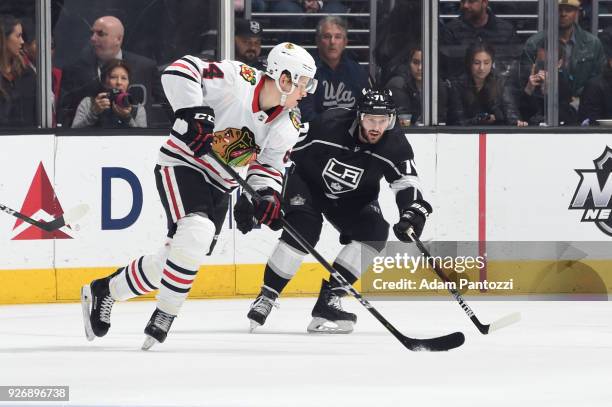 David Kampf of the Chicago Blackhawks handles the puck against Torrey Mitchell of the Los Angeles Kings at STAPLES Center on March 3, 2018 in Los...