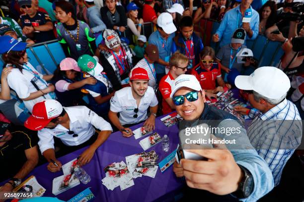 In this handout provided by FIA Formula E, Daniel Abt , Audi Sport ABT Schaeffler, Audi e-tron FE04, poses for an selfie with a fan. During the...