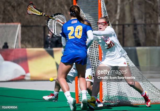 Maryland Kylie Davis attempts to block a shot by Hofstra Katie Whelan during a women's college Lacrosse game between the Maryland Terrapins and the...