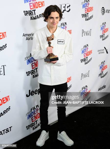 Actor Timothee Chalamet, with his Best Male Lead Award, poses in the press room during the 2018 Film Independent Spirit Awards, in Santa Monica,...