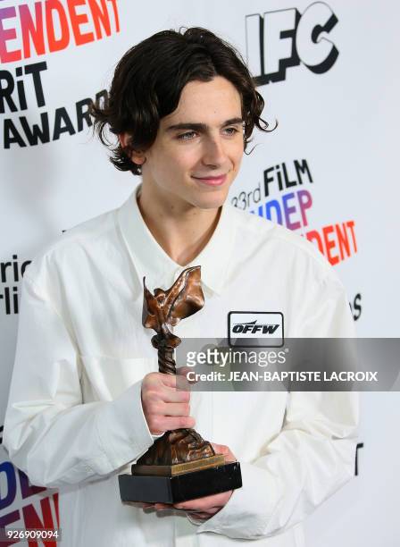 Actor Timothee Chalamet, with his Best Male Lead Award, poses in the press room during the 2018 Film Independent Spirit Awards, in Santa Monica,...