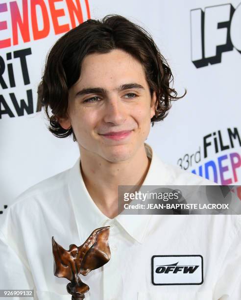 Actor Timothee Chalamet, with his Best Male Lead Award, poses in the press room during the 2018 Film Independent Spirit Awards, in Santa Monica,...