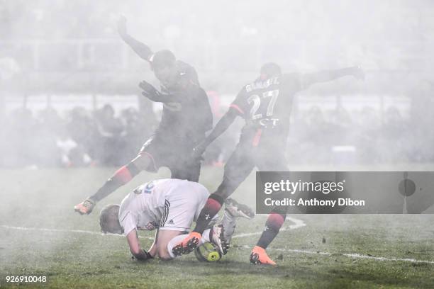 Players under the smoke during the Ligue 1 match between Amiens SC and Stade Rennais at Stade de la Licorne on March 3, 2018 in Amiens, .