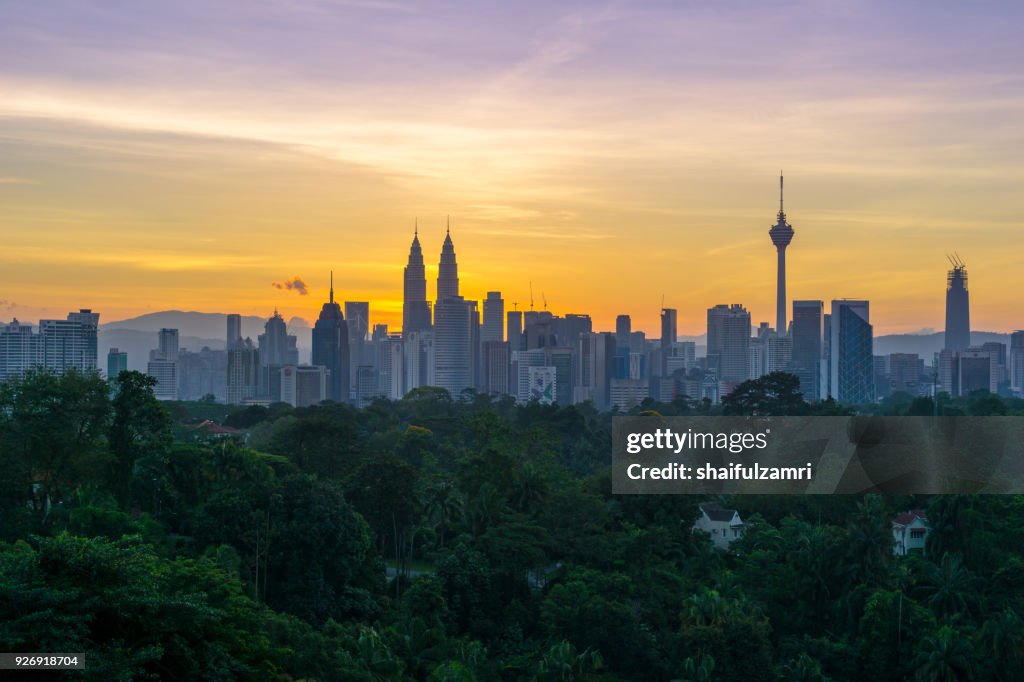 Majestic sunrise over Petronas Twin Towers and surrounded buildings in downtown Kuala Lumpur, Malaysia