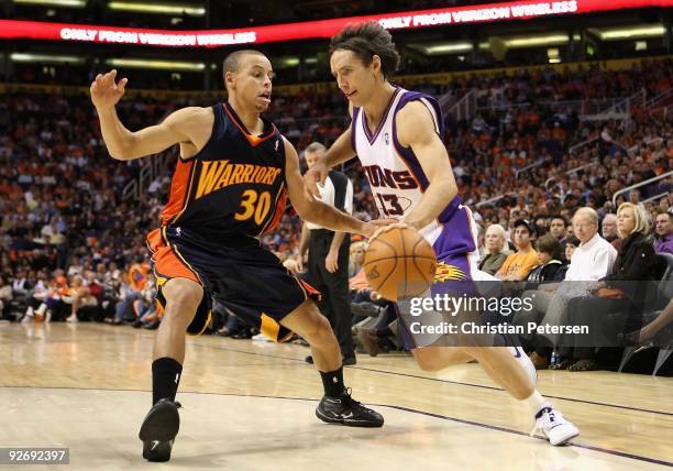 Steve Nash of the Phoenix Suns drives the ball past Stephen Curry of the Golden State Warriors during the NBA game at US Airways Center on October...