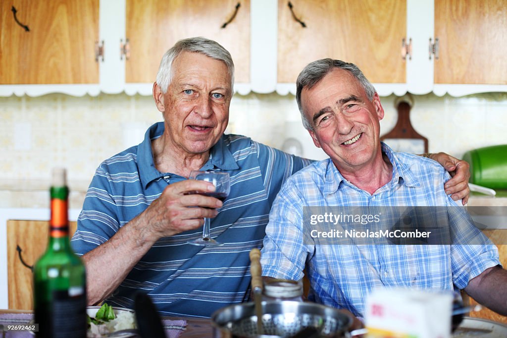 Couple of smiling male seniors at meal time