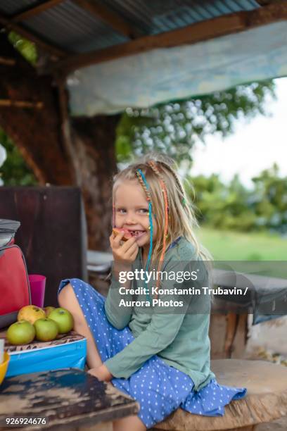 smiling girl eating apple, nusa penida, bali, indonesia - bent ladder stock pictures, royalty-free photos & images