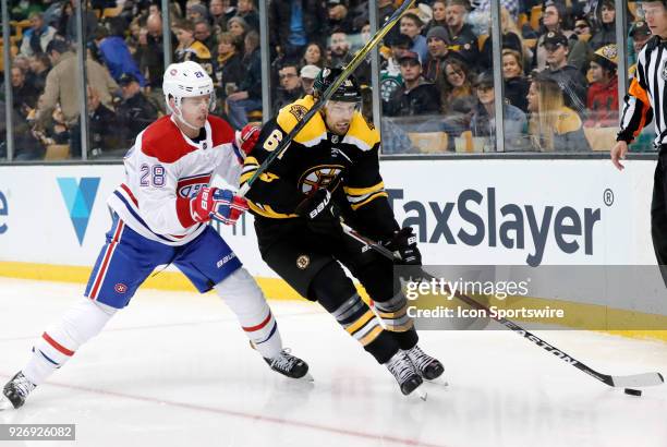 Montreal Canadiens defenseman Mike Reilly high sticks Boston Bruins right wing Rick Nash during a game between the Boston Bruins and the Montreal...