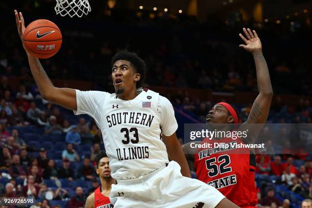 Kavion Pippen of the Southern Illinois Salukis looks to pull down a rebound against Milik Yarbrough of the Illinois State Redbirds during the...