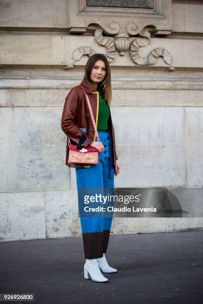Angelica Ardasheva, wearing brown leather jacket and green sweater, is seen in the streets of Paris before the Vivienne Westwood show during Paris...
