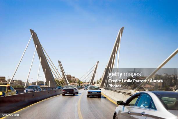 driving across wadi abdoun bridge in amman, jordan - capital cities stock pictures, royalty-free photos & images