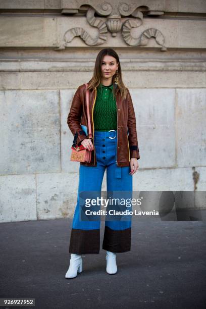 Angelica Ardasheva, wearing brown leather jacket and green sweater, is seen in the streets of Paris before the Vivienne Westwood show during Paris...
