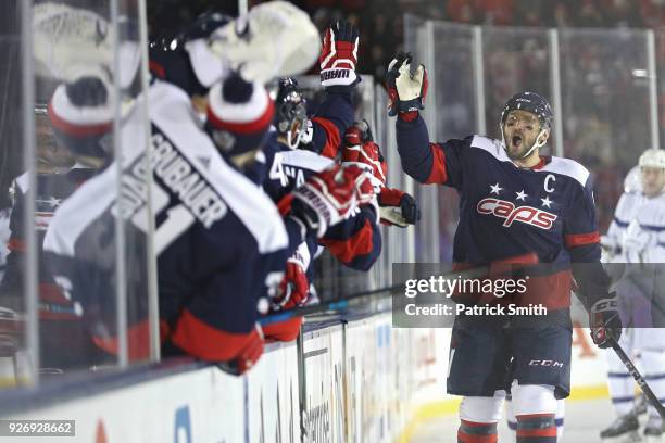 Alex Ovechkin of the Washington Capitals celebrates a goal by teammate Evgeny Kuznetsov against the Toronto Maple Leafs during the first period in...