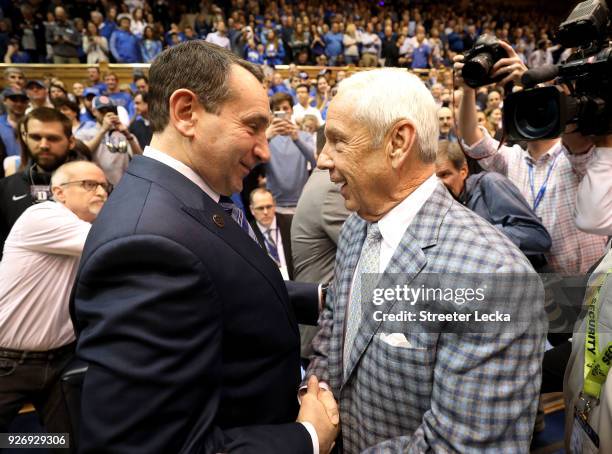 Head coach Mike Krzyzewski of the Duke Blue Devils talks to head coach Roy Williams of the North Carolina Tar Heels before their game at Cameron...