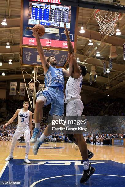 Luke Maye of the North Carolina Tar Heels goes to the basket against Marques Bolden of the Duke Blue Devils at Cameron Indoor Stadium on March 3,...