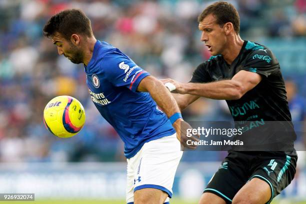 Martin Cauteruccio of Cruz Azul and Diego Novaretti of Queretaro fight for the ball during the 10th round match between Cruz Azul and Queretaro as...