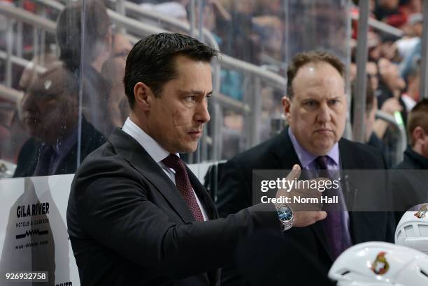 Head coach Guy Boucher of the Ottawa Senators looks on from the bench during second period action against the Arizona Coyotes at Gila River Arena on...