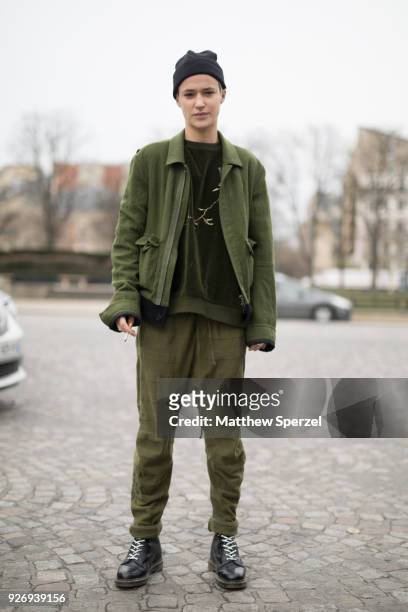 Agathe Mougin is seen on the street attending Haider Ackermann during Paris Women's Fashion Week A/W 2018 wearing an army green outfit with black...