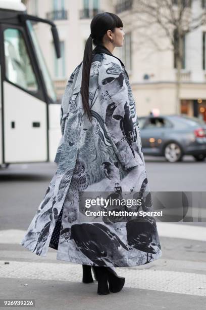 Kozue Akimoto is seen on the street attending Comme des Garons during Paris Women's Fashion Week A/W 2018 wearing a grey animal print design coat,...