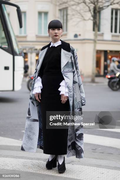 Kozue Akimoto is seen on the street attending Comme des Garons during Paris Women's Fashion Week A/W 2018 wearing a grey animal print design coat,...