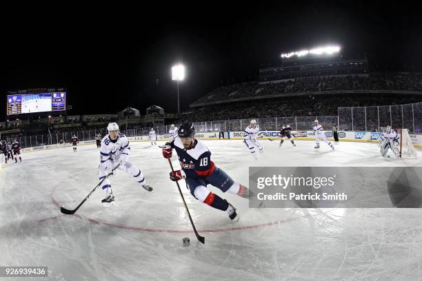 Chandler Stephenson of the Washington Capitals skates past Mitchell Marner of the Toronto Maple Leafs during the second period in the Coors Light NHL...