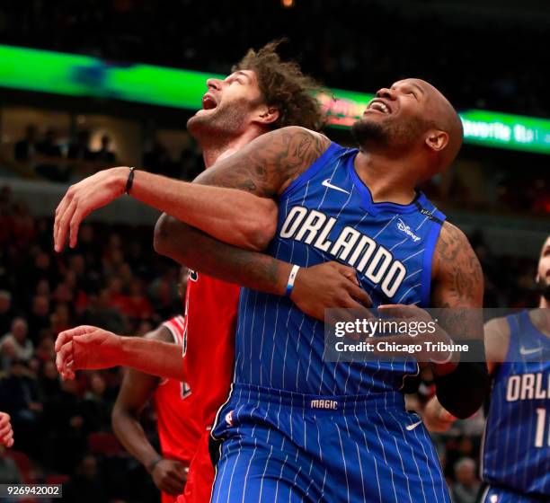 In a February 12 file image, Chicago Bulls center Robin Lopez and Orlando Magic forward Marreese Speights watch for the rebound at the United Center...