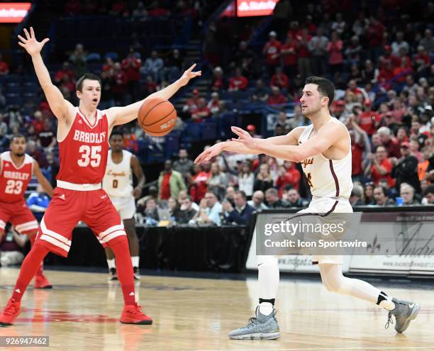 Loyola guard Ben Richardson passes the ball while guarded by Bradley guard Jayden Hodgson during a Missouri Valley Conference Basketball Tournament...