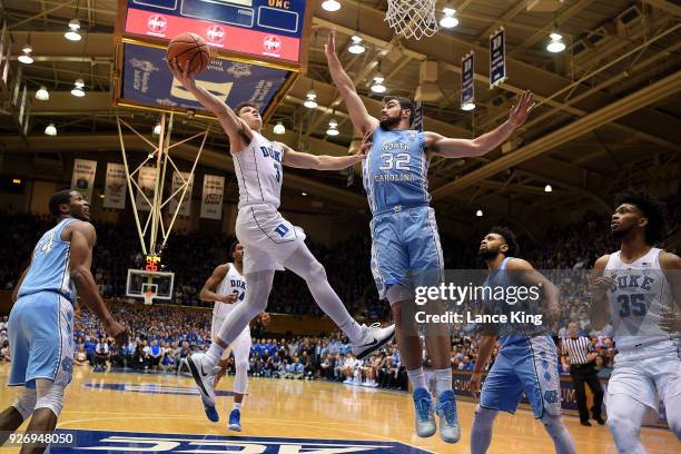 Grayson Allen of the Duke Blue Devils goes to the basket against Luke Maye of the North Carolina Tar Heels at Cameron Indoor Stadium on March 3, 2018...